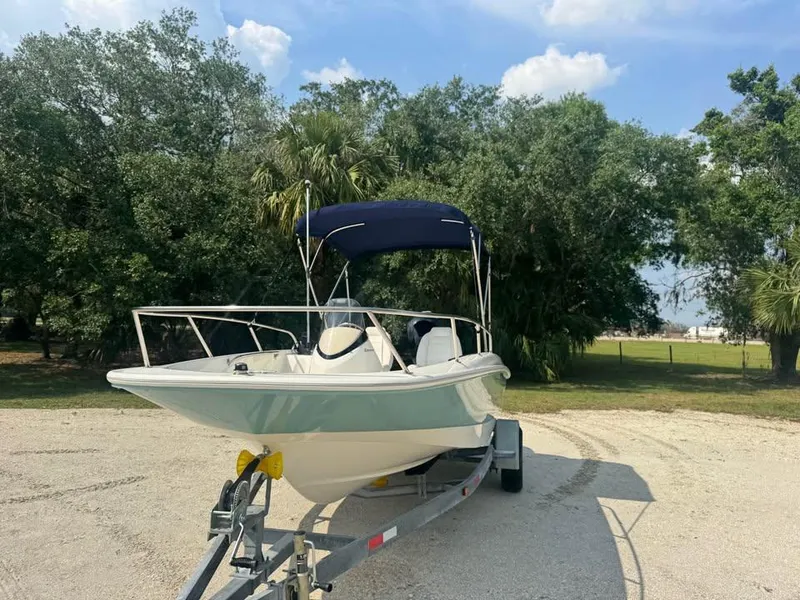 Slide: The Image of 2016 Boston Whaler 170 Super Sport boat on trailer, parked outdoors. - 8