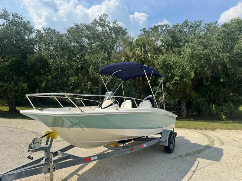 Slide: The Image of 2016 Boston Whaler 170 Super Sport boat on trailer, parked outdoors. - 9