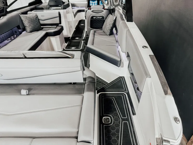 Slide: The Image of 2025 Cobalt R8 Surf boat interior with luxurious seating and modern design. - 11