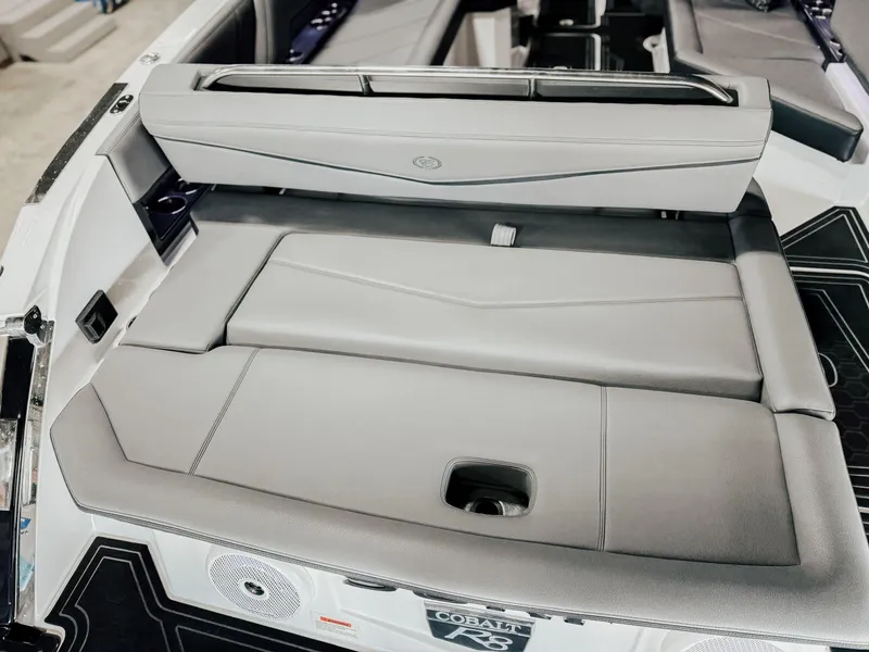 Slide: The Image of 2025 Cobalt R8 Surf boat interior with sleek gray seating and modern design. - 12