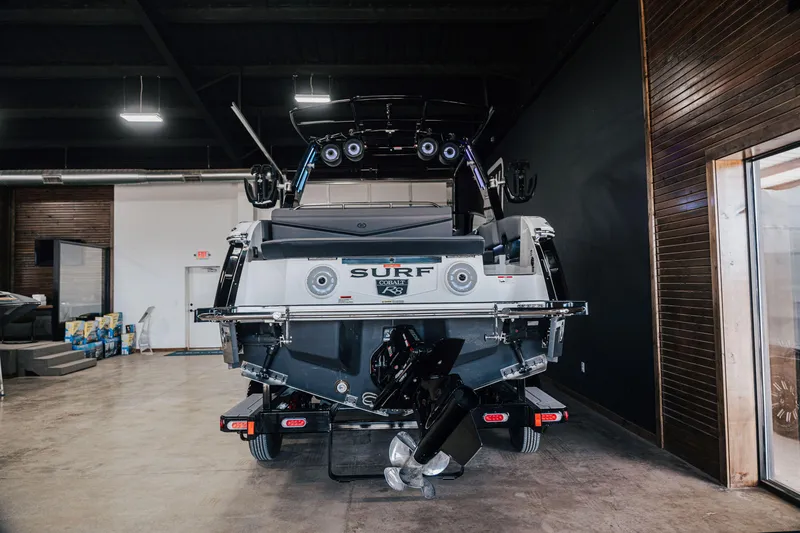 Slide: The Image of 2025 Cobalt R8 Surf boat in showroom, rear view with sleek design and advanced features. - 14