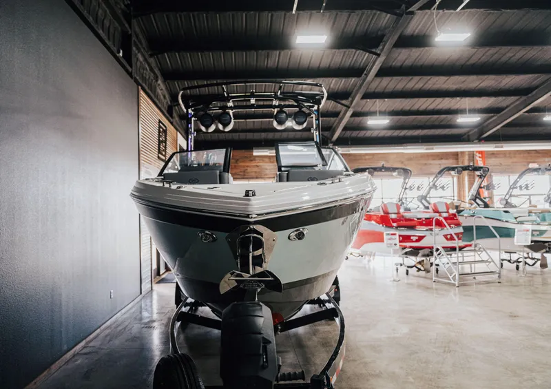 Slide: The Image of 2025 Cobalt R8 Surf boat displayed in a showroom with other boats. - 3