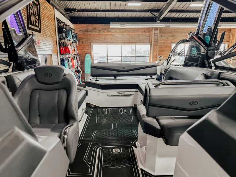 Slide: The Image of 2025 Cobalt R8 Surf boat interior with sleek seating and modern design in showroom. - 5