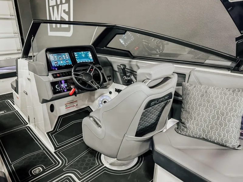 Slide: The Image of 2025 Cobalt R8 Surf boat interior with modern dashboard and comfortable seating. - 7