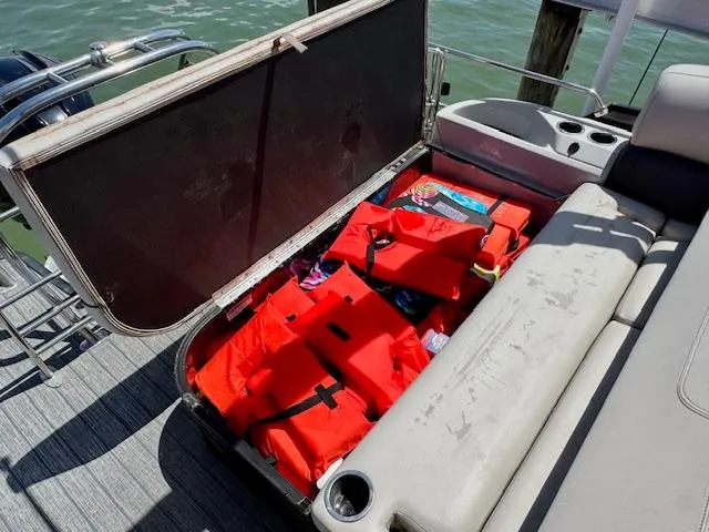 Slide: The Image of 2022 Starcraft CX 25 Q DH boat dashboard with steering wheel and control panel. - 19