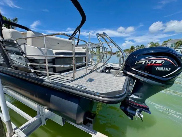 Slide: The Image of 2022 Starcraft CX 25 Q DH pontoon boat with Yamaha engine on a sunny day. - 2