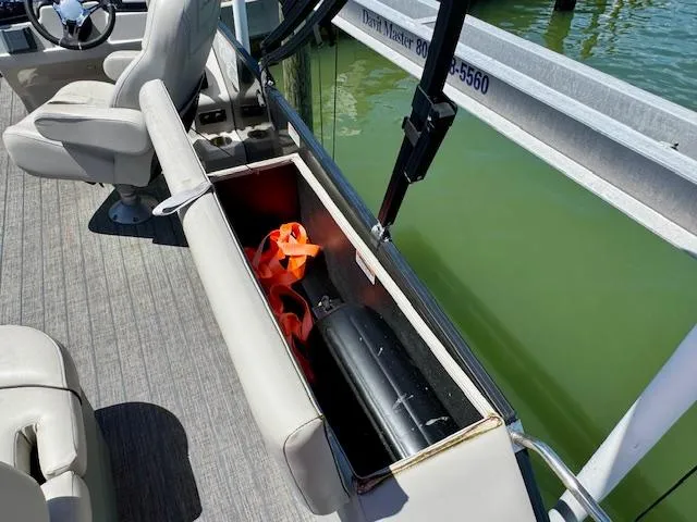 Slide: The Image of 2022 Starcraft CX 25 Q DH boat dashboard with steering wheel and controls. - 20