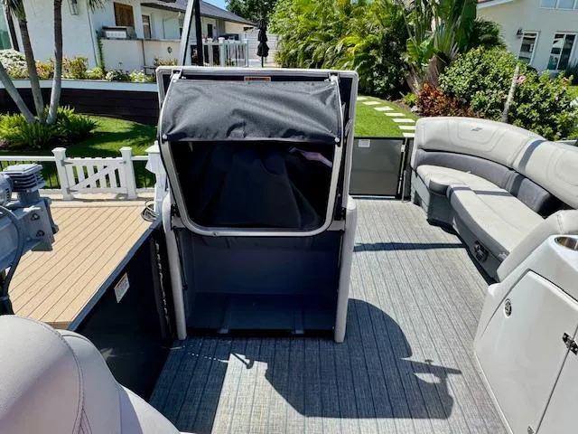 Slide: The Image of 2022 Starcraft CX 25 Q DH pontoon boat interior with seating and storage. - 27