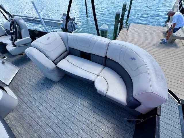 Slide: The Image of 2022 Starcraft CX 25 Q DH boat with curved seating, docked by the water. - 28