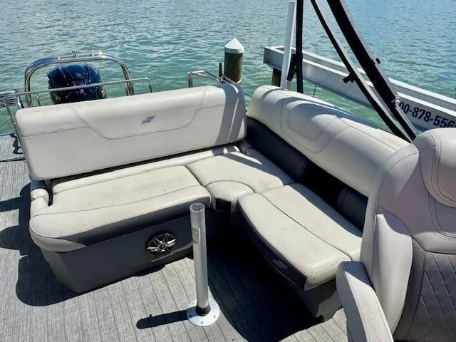 Slide: The Image of 2022 Starcraft CX 25 Q DH boat interior with comfortable seating and water view. - 29