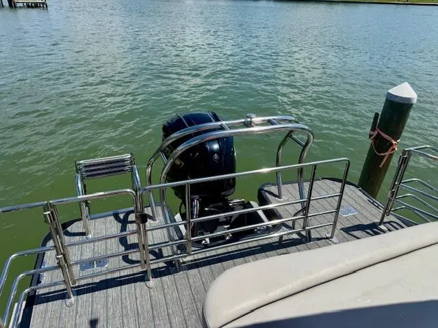 Slide: The Image of 2022 Starcraft CX 25 Q DH boat with outboard motor on calm water. - 34