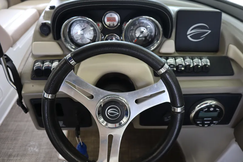 Slide: The Image of 2019 Crownline Eclipse E215 XS boat dashboard with steering wheel and gauges. - 10