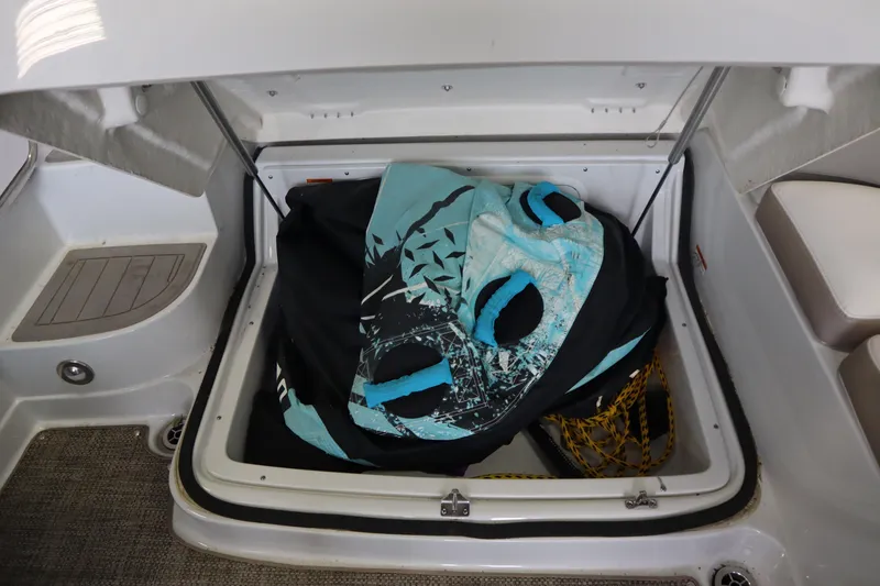 Slide: The Image of 2019 Crownline Eclipse E215 XS storage compartment with water sports gear. - 11