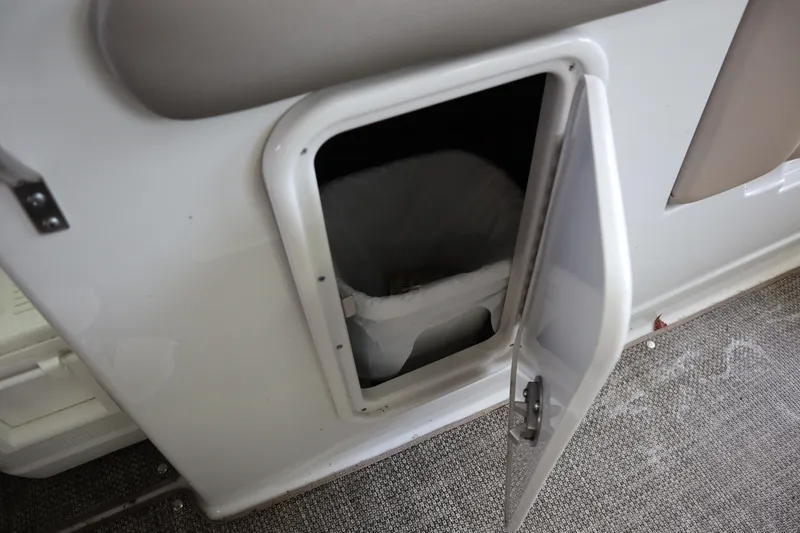 Slide: The Image of Open storage compartment on 2019 Crownline Eclipse E215 XS boat interior. - 17