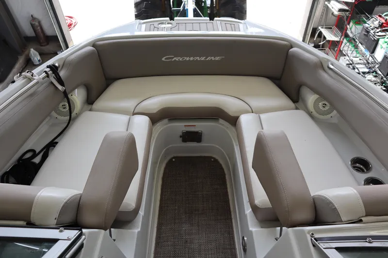 Slide: The Image of 2019 Crownline Eclipse E215 XS boat interior with beige seating and cup holders. - 4