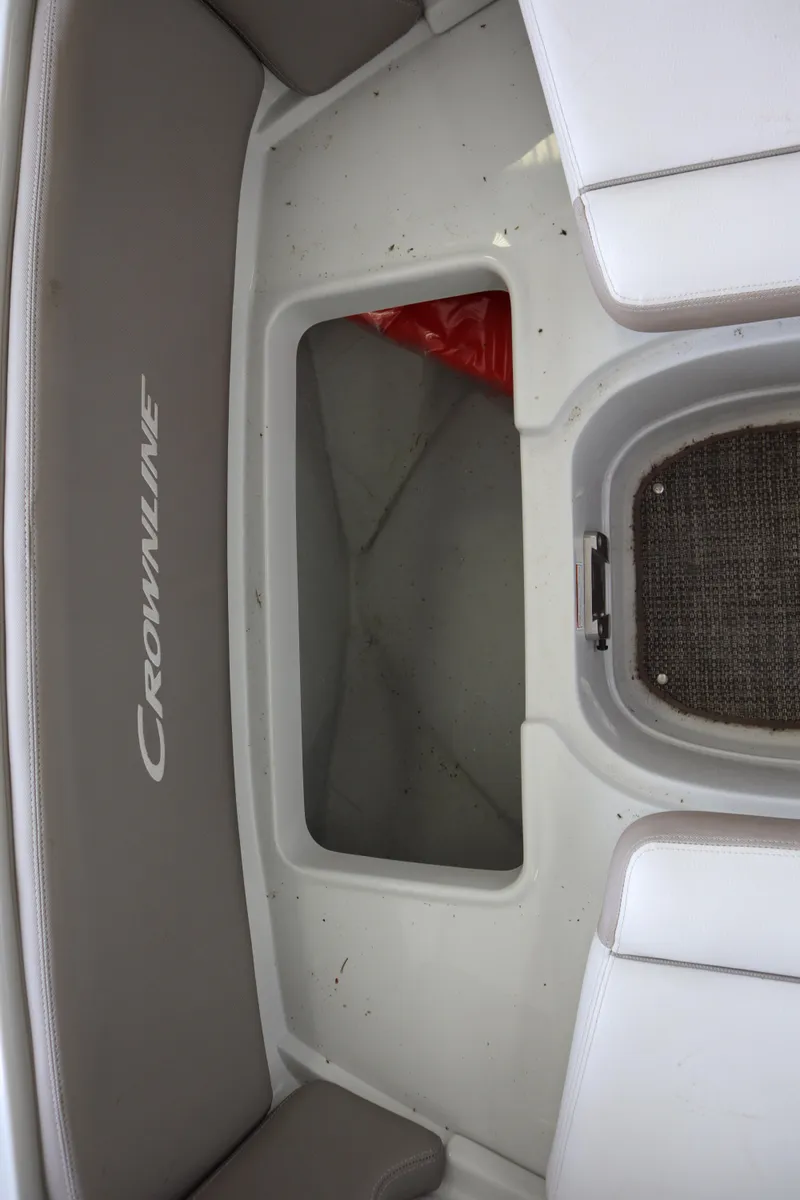 Slide: The Image of 2019 Crownline Eclipse E215 XS boat interior with seating and storage area. - 7