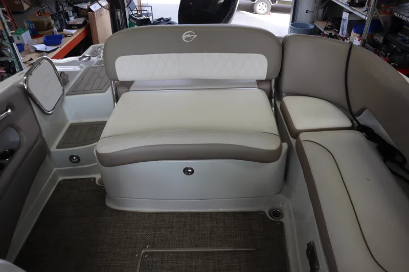 Slide: The Image of 2019 Crownline Eclipse E215 XS boat interior with cushioned seating and storage compartments. - 8