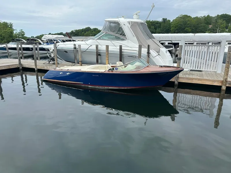 Slide: The Image of 2015 Comitti Venezia 22 boat docked at marina, calm water reflection. - 0