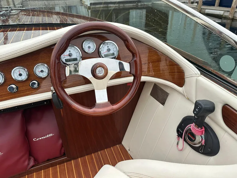 Slide: The Image of Interior of a 2015 Comitti Venezia 22 boat with wooden steering wheel and gauges. - 13