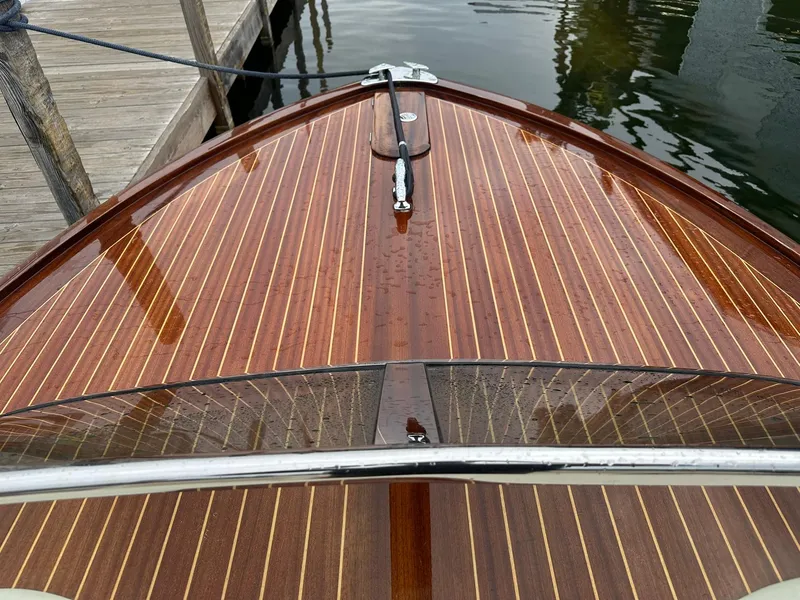 Slide: The Image of Wooden deck of a 2015 Comitti Venezia 22 boat, docked by the water. - 15