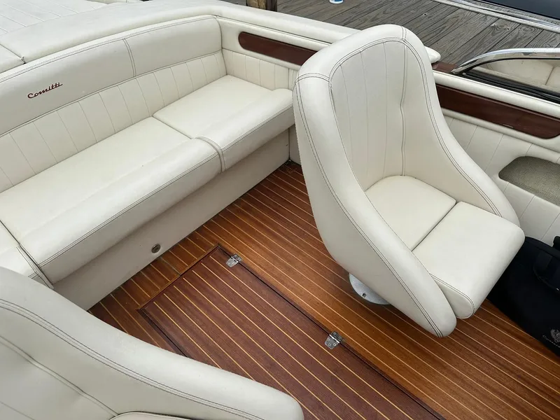 Slide: The Image of Interior of 2015 Comitti Venezia 22 boat with white leather seats and wooden flooring. - 19
