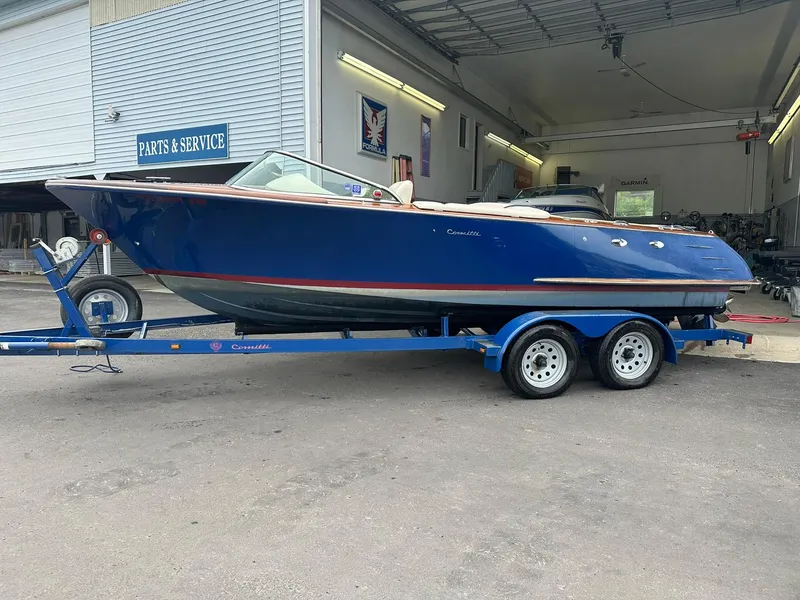 Slide: The Image of 2015 Comitti Venezia 22 boat on trailer outside service garage. - 2