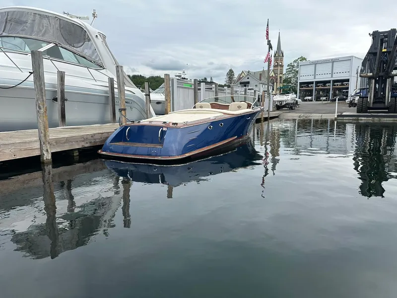 Slide: The Image of 2015 Comitti Venezia 22 boat docked at a marina with calm water reflections. - 6