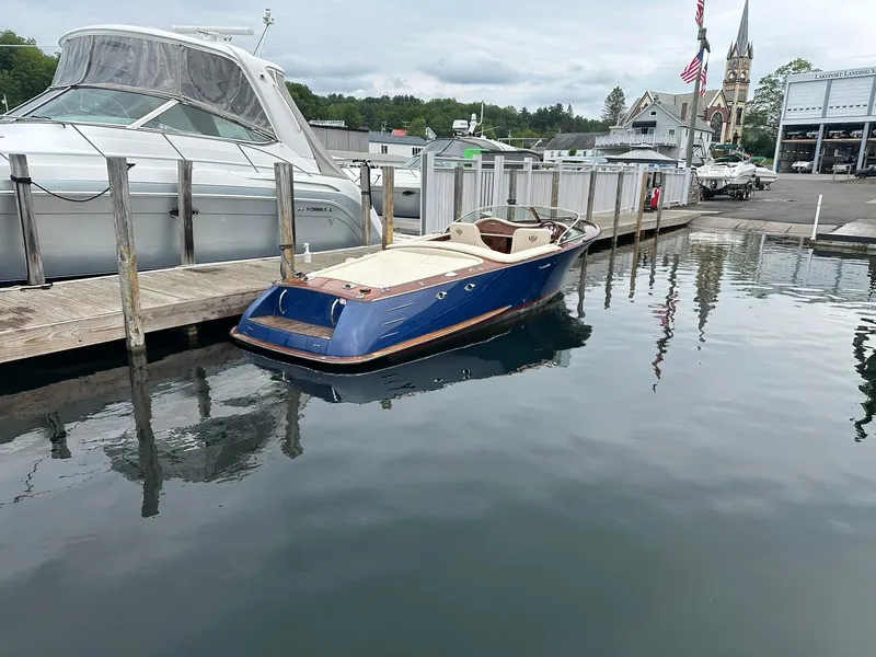 Slide: The Image of 2015 Comitti Venezia 22 boat docked at a marina, with a church in the background. - 7
