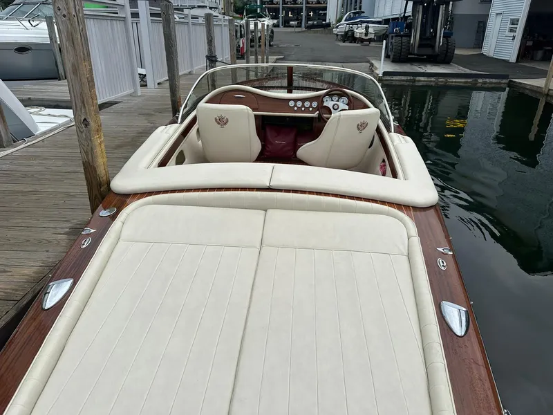 Slide: The Image of 2015 Comitti Venezia 22 luxury boat with cream leather interior at a marina dock. - 9