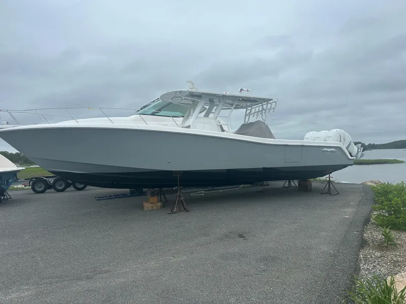 Slide: The Image of 2020 Invincible 39 Open Fisherman boat on dry dock, overcast sky background. - 1