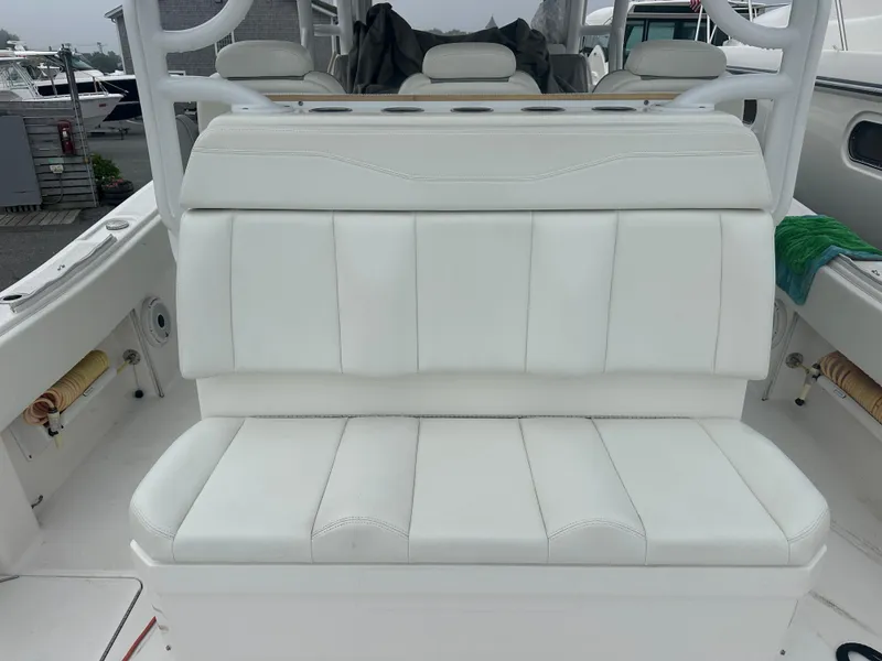 Slide: The Image of White seating on 2020 Invincible 39 Open Fisherman boat, featuring cushioned backrest and armrests. - 10