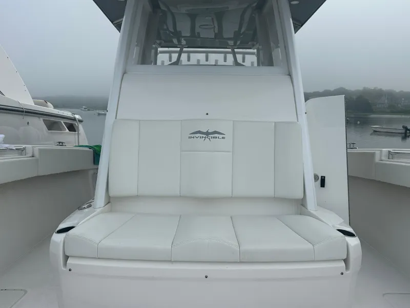 Slide: The Image of 2020 Invincible 39 Open Fisherman boat with white seating, docked on a foggy day. - 11