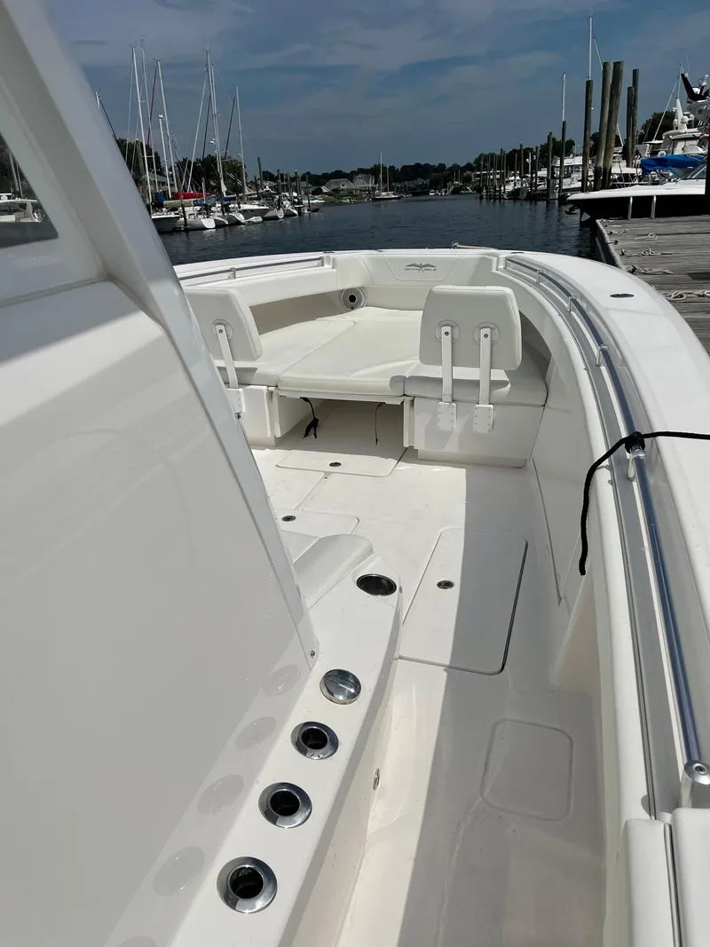 Slide: The Image of 2020 Invincible 39 Open Fisherman boat docked at marina, showcasing spacious deck. - 16