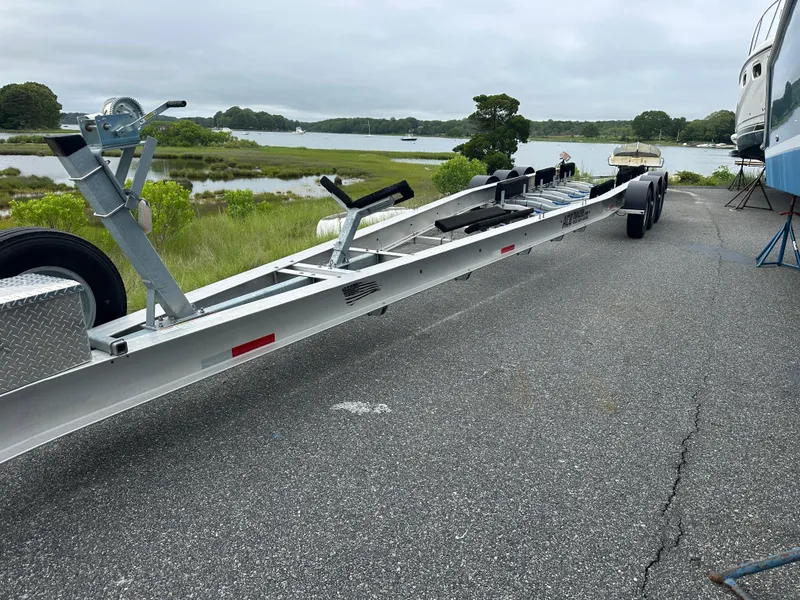 Slide: The Image of Trailer for 2020 Invincible 39 Open Fisherman by a scenic waterfront. - 19