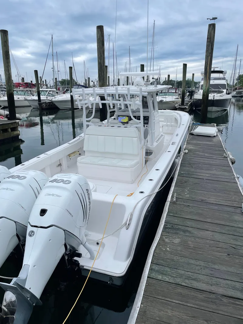 Slide: The Image of 2020 Invincible 39 Open Fisherman boat docked at marina with twin engines. - 6