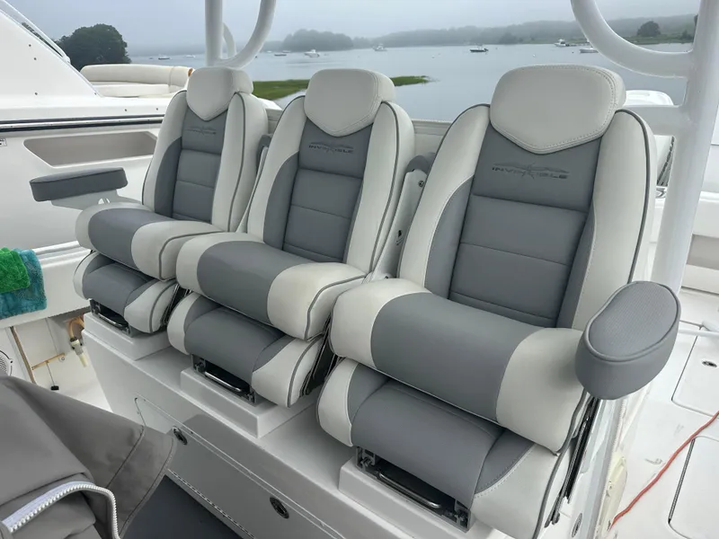 Slide: The Image of 2020 Invincible 39 Open Fisherman boat seats, gray and white, with scenic water view. - 8