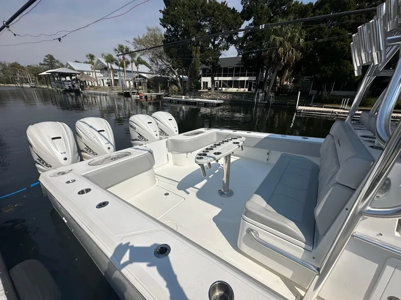 Slide: The Image of 2021 SeaHunter 46 CTS boat with four Yamaha V8 engines docked by waterfront homes. - 6