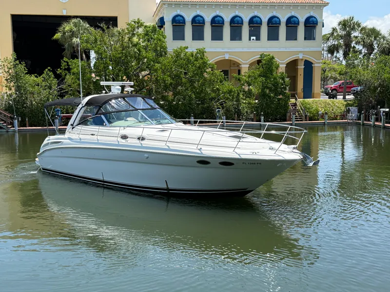 The Image of 2003 Sea Ray 380 Sundancer yacht docked in a serene marina setting. - 1