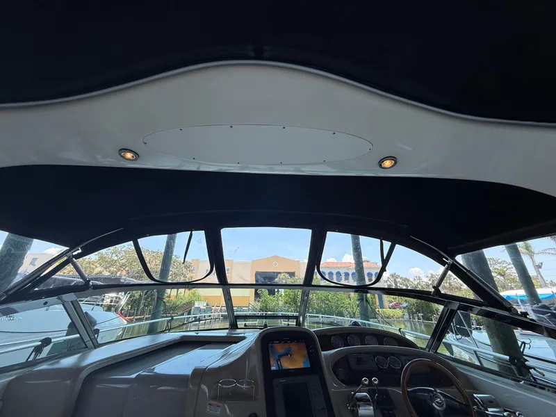 Slide: The Image of 2003 Sea Ray 380 Sundancer helm with dashboard and view through windshield. - 13