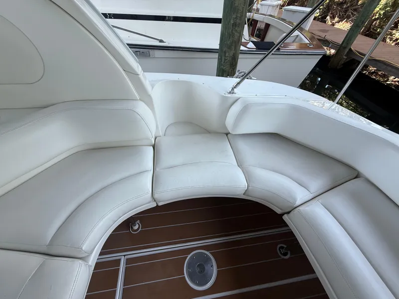 Slide: The Image of White leather seating on 2003 Sea Ray 380 Sundancer yacht, featuring elegant design and wood flooring. - 17