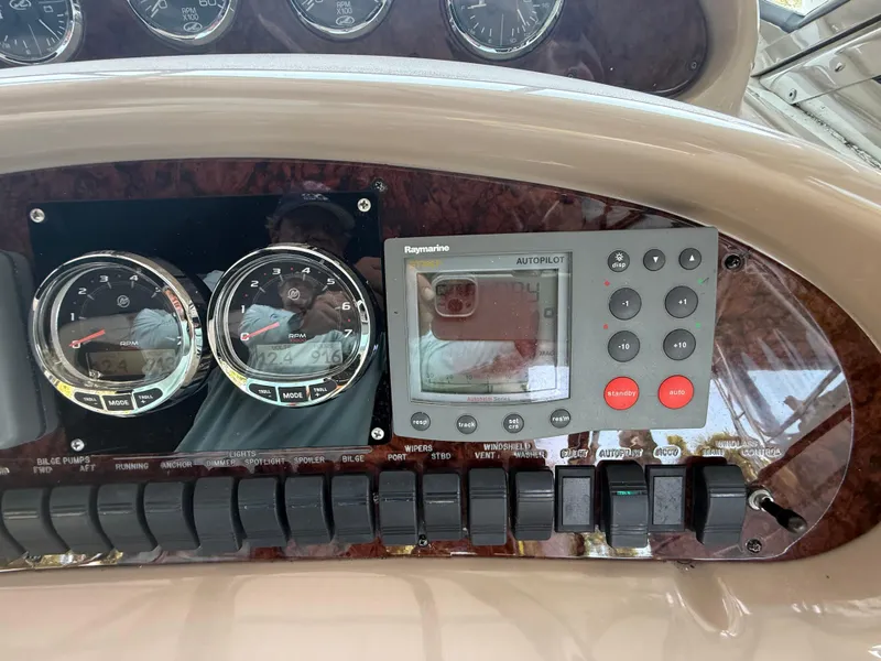 Slide: The Image of Control panel of a 2003 Sea Ray 380 Sundancer with gauges and autopilot system. - 22