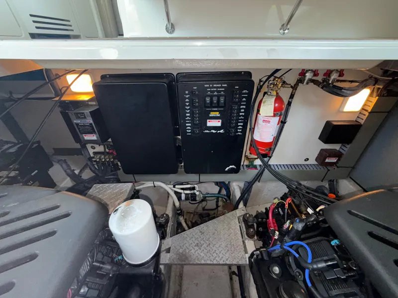 Slide: The Image of Engine room of 2003 Sea Ray 380 Sundancer with control panel and fire extinguisher. - 23
