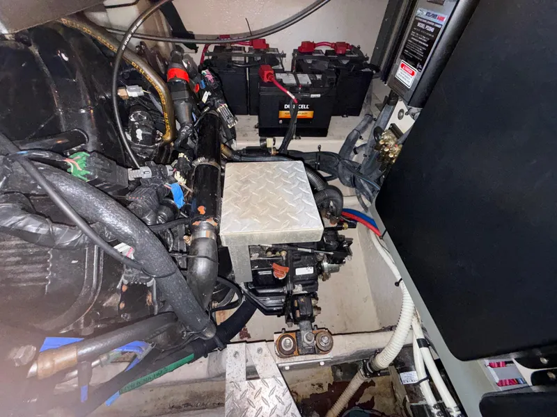 Slide: The Image of Engine compartment of a 2003 Sea Ray 380 Sundancer with visible batteries and wiring. - 25