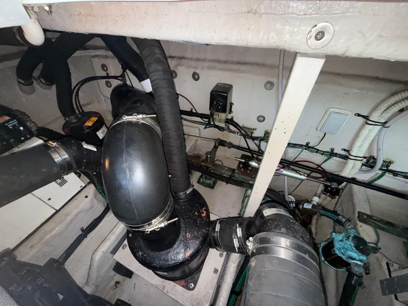 Slide: The Image of Engine room of a 2003 Sea Ray 380 Sundancer with visible hoses and wiring. - 29