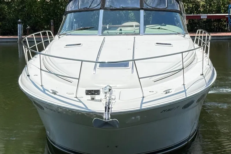 Slide: The Image of 2003 Sea Ray 380 Sundancer yacht docked on calm water. - 3