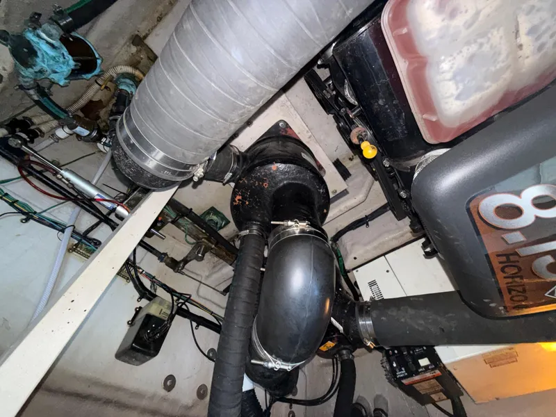 Slide: The Image of Engine room of 2003 Sea Ray 380 Sundancer with visible hoses and components. - 32