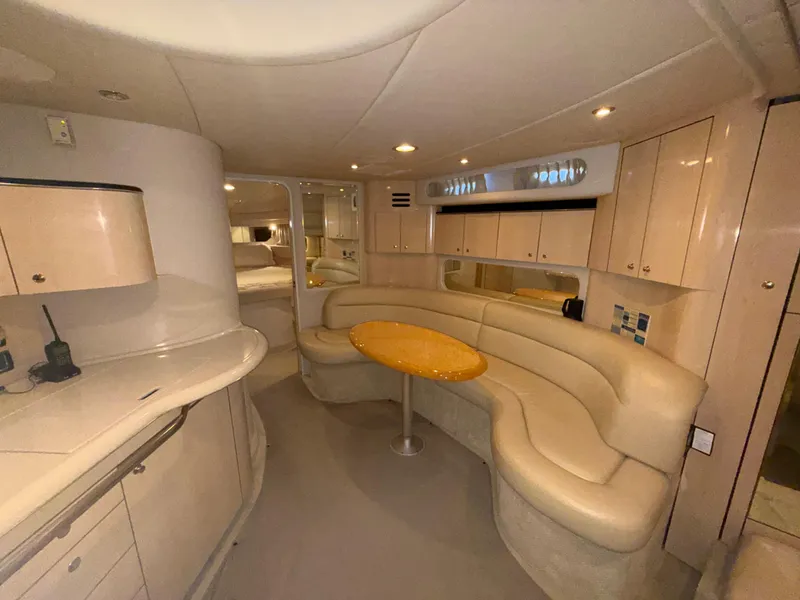 Slide: The Image of Luxurious interior of a 2003 Sea Ray 380 Sundancer yacht with plush seating and cabinetry. - 35