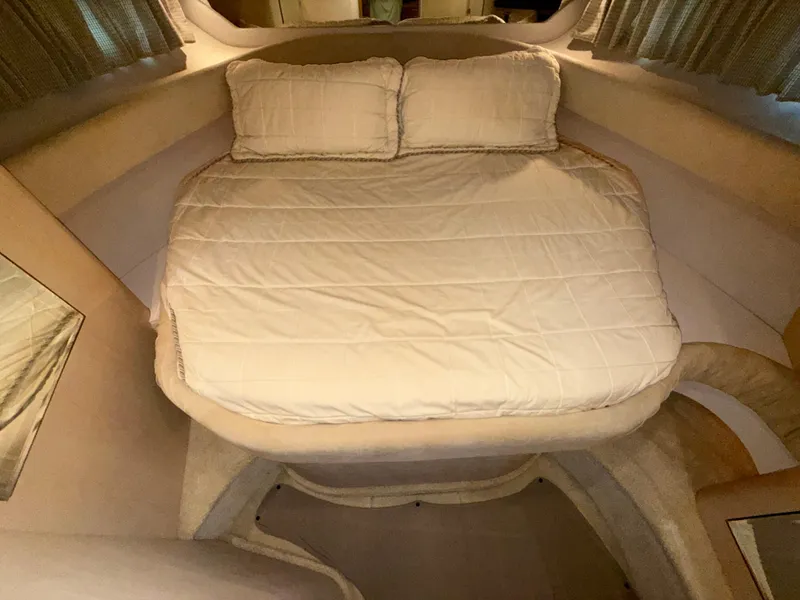 Slide: The Image of Cozy cabin interior of 2003 Sea Ray 380 Sundancer with a neatly made bed. - 36