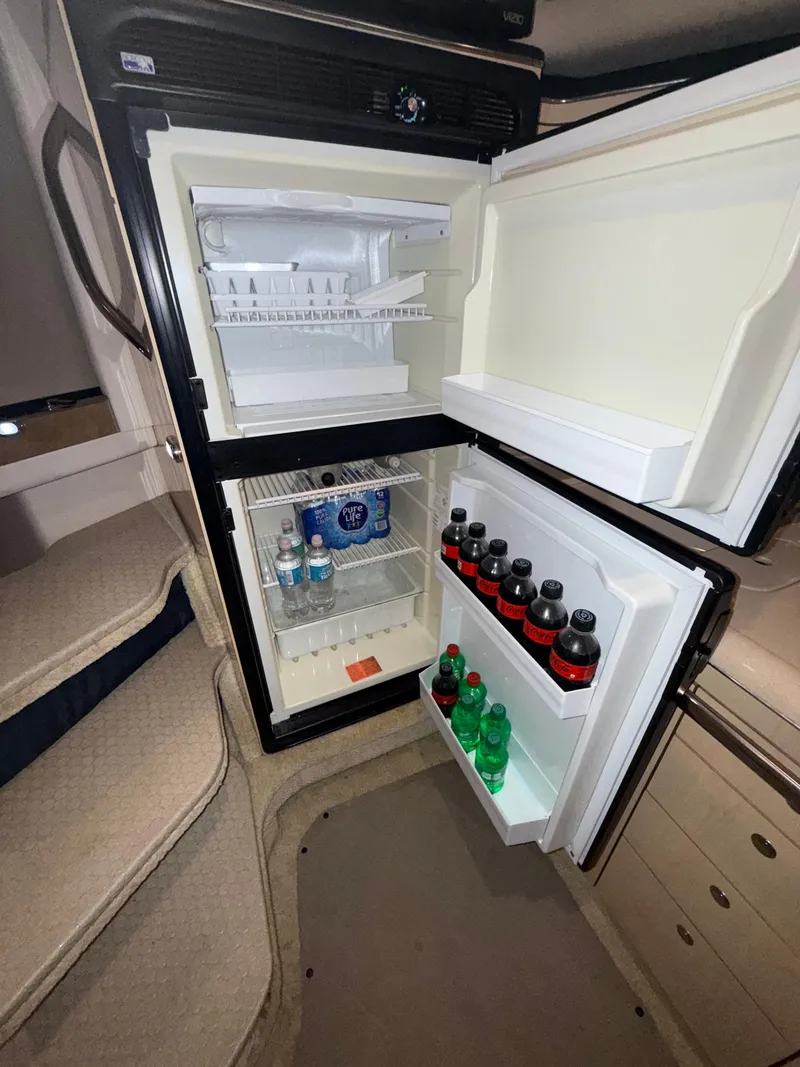 Slide: The Image of Open fridge inside 2003 Sea Ray 380 Sundancer yacht, stocked with beverages. - 43