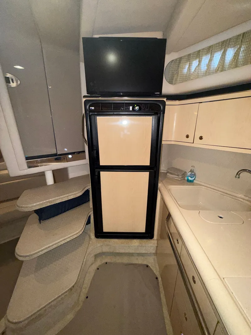 Slide: The Image of Interior of 2003 Sea Ray 380 Sundancer with kitchenette and TV. - 44